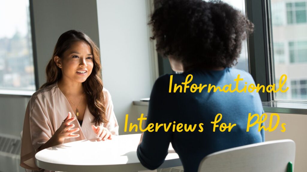Two women sitting at a round table seemingly engaged in conversation. Text overlay: Informational Interviews for PhDs.